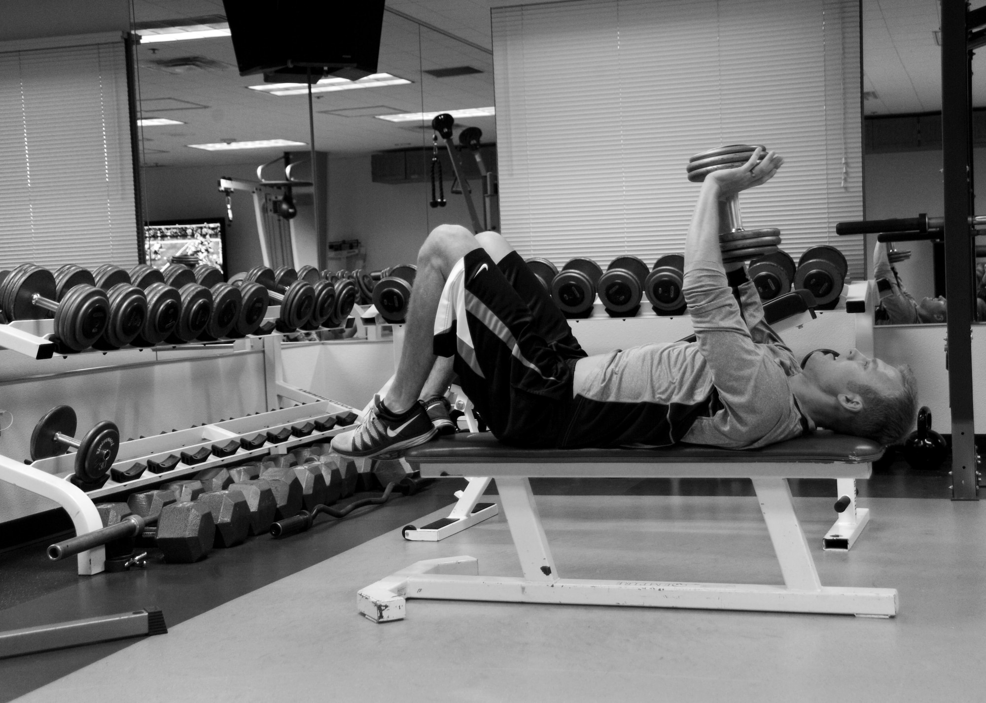 Oregon Air National Guard Capt. Joshua Pfeifer, a pilot assigned to the 123rd Fighter Squadron, 142nd Fighter Wing, Portland Air National Guard Base, Ore., exercises in the Alert Facility gym, Nov. 27, 2014. Pfeifer is one of six Airmen on duty during the Thanksgiving holiday supporting the Aerospace Control Alert mission. (U.S. Air National Guard photo by Tech. Sgt. John Hughel, 142nd Fighter Wing Public Affairs/Released)