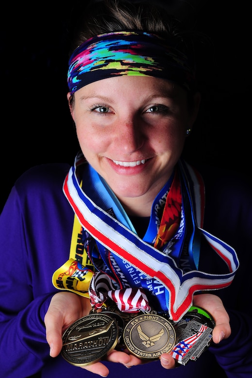 U.S. Air Force 2nd Lieutenant Abigail Webber, 633rd Inpatient Squadron labor and delivery nurse, dons medals from past half and full marathons, Nov. 19, 2014, at Langley Air Force Base, Va.  Webber started running after her sister joined a cross country team, and since then, it has become a family activity. Both Webber and her sister, Holly, have ran half and full marathons with their father, retired U.S. Air Force Col. (Dr.) Gary Frederickson. (U.S. Air Force photo by Staff Sgt. Natasha Stannard/Released)  