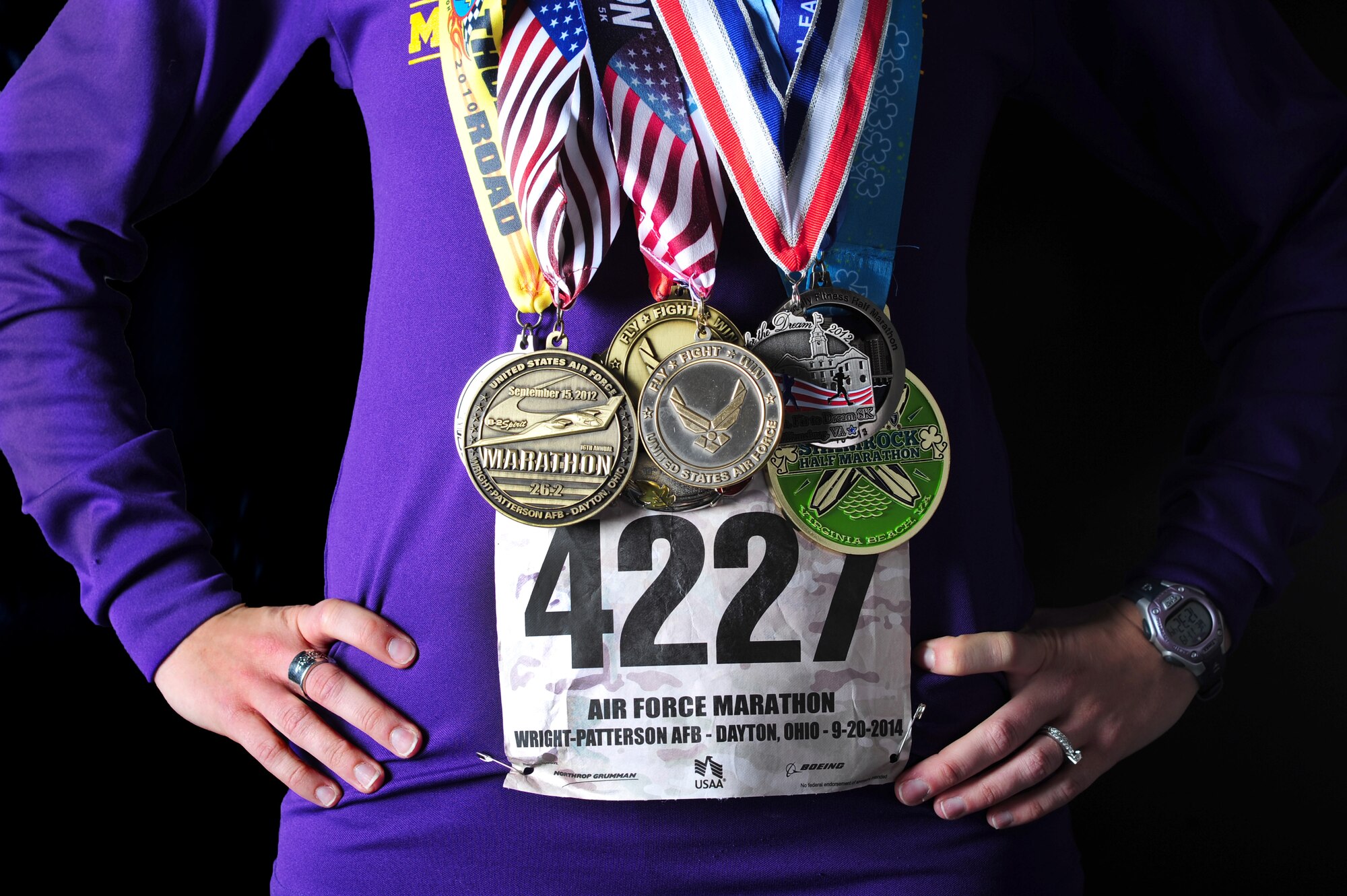 U.S. Air Force 2nd Lt. Abigail Webber, 633rd Inpatient Squadron labor and delivery nurse, wears her 2014 Air Force marathon bib number and medals from past half and full marathons, Nov. 19, 2014, at Langley Air Force Base, Va. Webber has run competitively since she joined her seventh grade cross country team at age 13. (U.S. Air Force photo by Staff Sgt. Natasha Stannard/Released)  