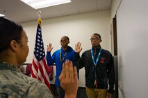Double Vision: Twin 18 year-olds Jonathan (left) and Gabriel Green raised their right hands November 25th to recite the Oath of Enlistment to become C-17 Globemaster III crew chiefs for the 712th Aircraft Maintenance Squadron, here on Dover Air Force Base, DE.