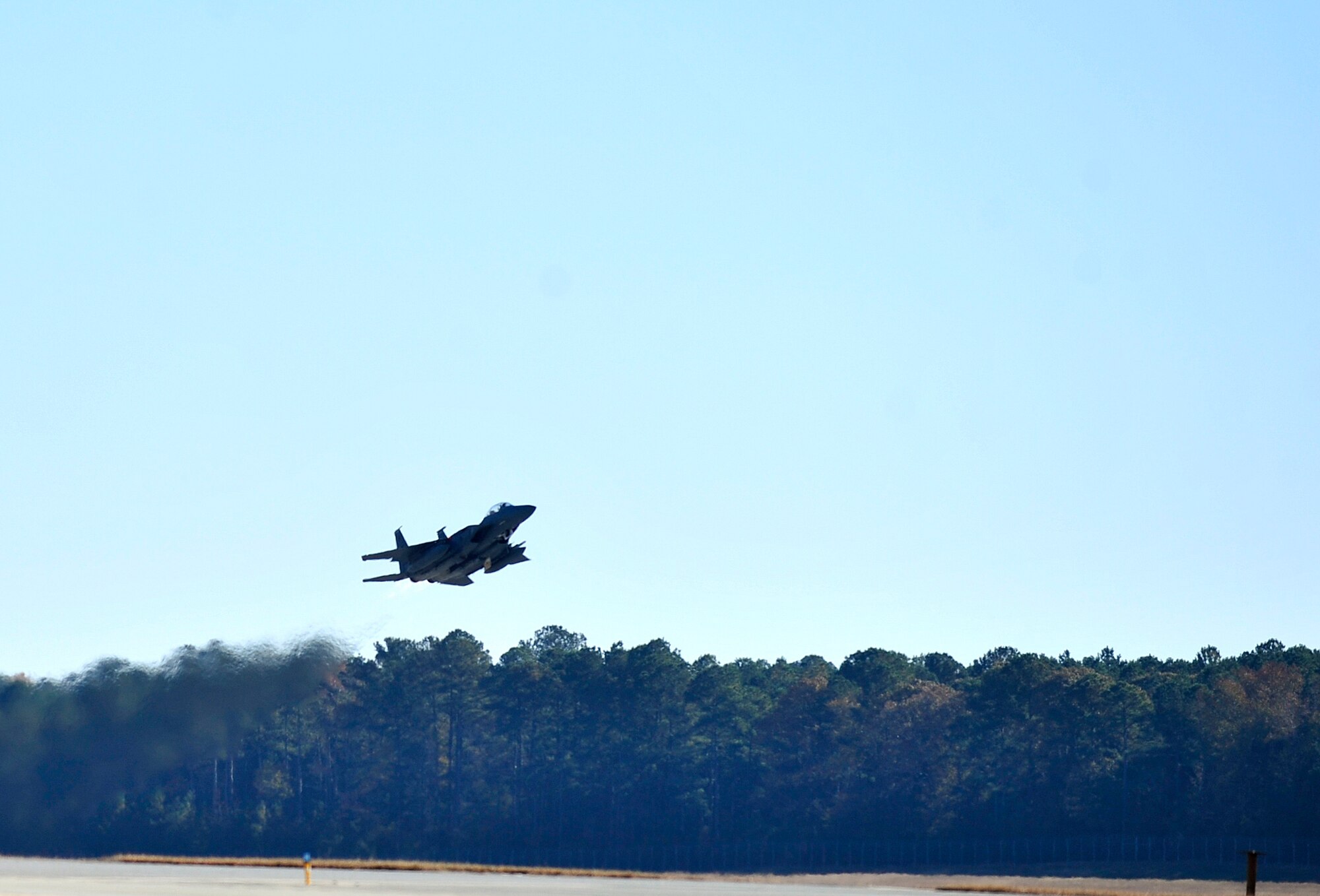 An F-15E Strike Eagle takes off from the flightline during exercise Coronet Warrior 14-03 at Seymour Johnson Air Force Base, North Carolina, Nov. 20, 2014. The base’s fleet of F-15Es completed simulated combat sorties honing their ability to provide accurate Strike Eagle airpower during worldwide contingency operations. (U.S. Air Force photo/Airman Shawna L. Keyes)