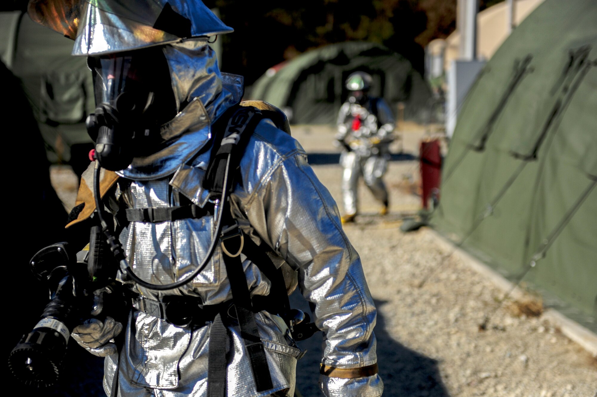 Airmen assigned to the 4th Civil Engineer Squadron respond to a simulated fire during exercise Coronet Warrior 14-03 at Seymour Johnson Air Force Base, North Carolina, Nov. 20, 2014. The 4th Fighter Wing regularly conducts exercises like Coronet Warrior to prepare Airmen for contingency operations in deployed environments. (U.S. Air Force photo/Airman 1st Class Brittain Crolley)