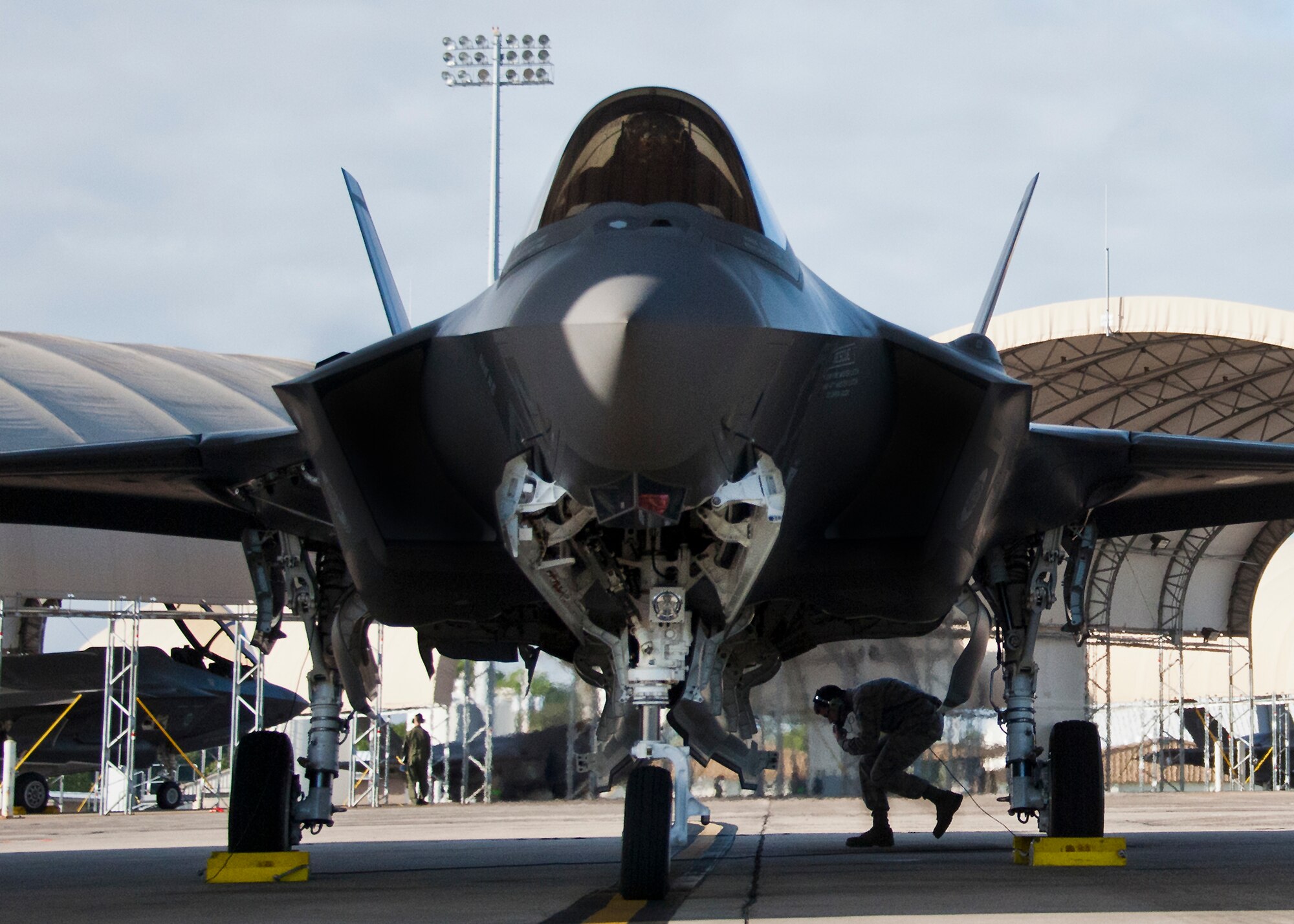 Airman 1st Class John Patterson, 33rd Aircraft Maintenance Squadron, moves underneath the F-35A Lightning II during preflight checks prior to a sortie at Eglin Air Force Base, Fla. The 33rd Maintenance Group is responsible for the maintenance of the Air Force’s joint strike fighter fleet on base. (U.S. Air Force photo/Samuel King Jr.