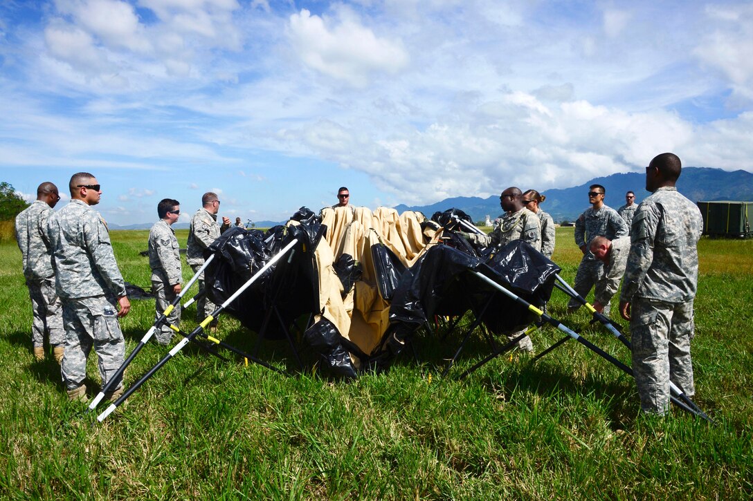 U.S. troops learn how to set up a Deployable Rapid Assembly Shelter during air load and fly-away training on Soto Cano Air Base, Honduras, Nov. 25, 2014.