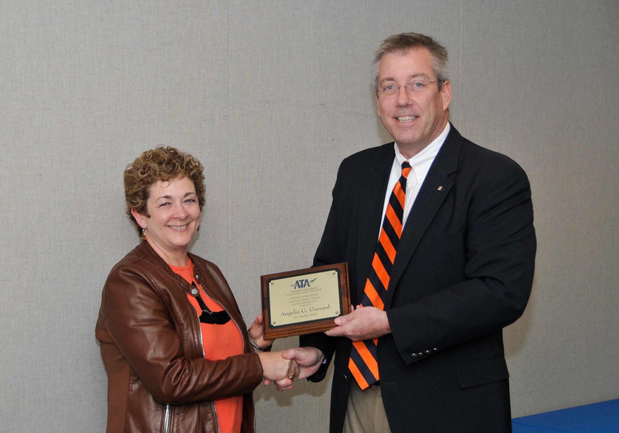 Angelia Garrard (left), with the ATA Mission Support Department, accepts the ATA External Customer Service Excellence of the Quarter Award from ATA Deputy General Manager Jeff Haars.