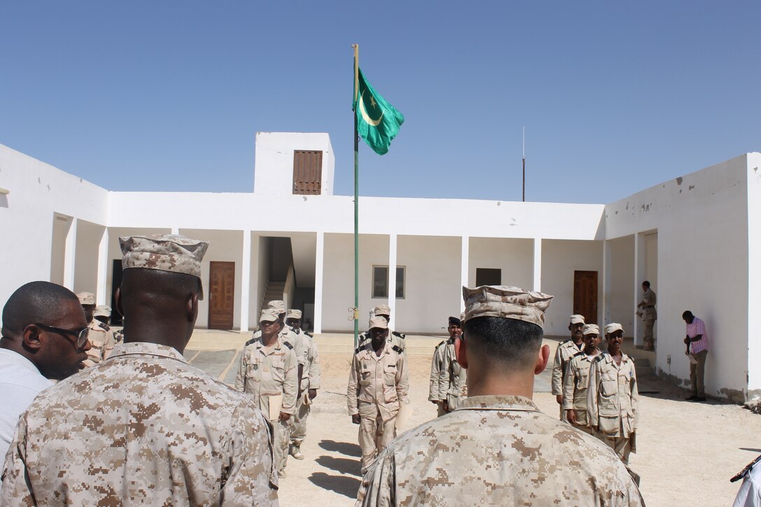 A formation of U.S. Marines, Coast Guardsmen and service members from the La Marine Nationale Mauritanienne at the commencement of their award ceremony, in Nouakchott, Mauritania, Nov 13, 2014. Security Cooperation Team-7, a group of Marines and Coast Guardsmen from SPMAGTF-Crisis Response-Africa worked alongside the Mauritanian Navy, teaching outboard motor maintenance. (Courtesy Photo by Petty Officer 2nd Class Michael Vadala, U.S. Coast Guard)