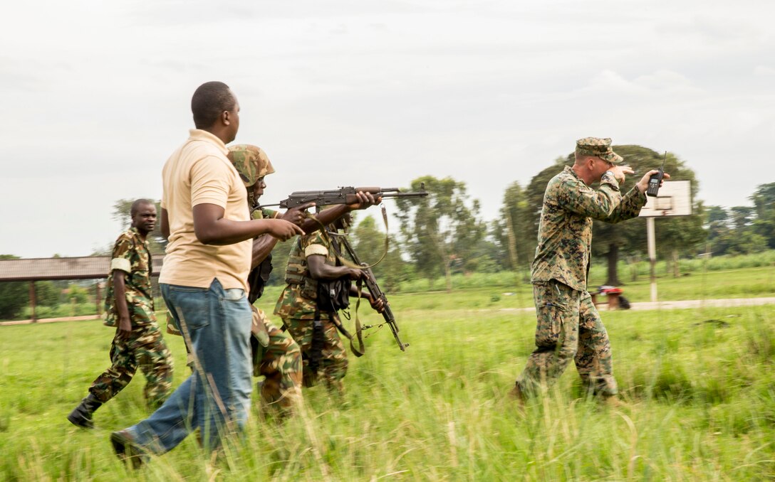 Staff Sergeant Jay Baldino instructs soldiers with the Burundi National Defense Force (BNDF) on infantry tactics in Bujumbura, Burundi, Nov. 6, 2014. Baldino is an infantry unit leader with SPMAGTF-Crisis Response- Africa, training alongside the BNDF, teaching basic infantry tactics, engineering, logistical support, countering-improvised explosive devices, lifesaving techniques, and convoy operations to prepare them for an upcoming deployment in support of the African Union Mission in Somalia (AMISOM). According to their website, AMISOM is tasked with “carrying out support for dialogue and reconciliation by assisting with free movement, safe passage and protection of all those involved in a national reconciliation congress involving all stakeholders, including political leaders, clan leaders, religious leaders and representatives of civil society.” (U.S. Marine Corps photo by Cpl. Shawn Valosin)