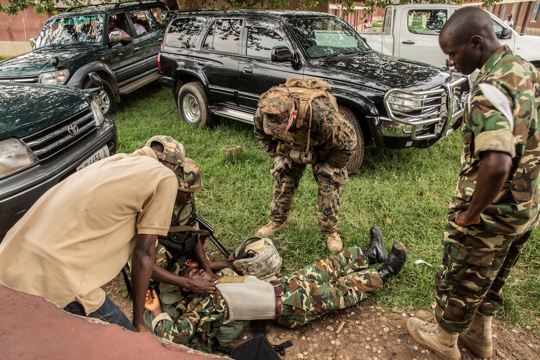 Petty Officer 3rd Class Zachary Gibson instructs soldiers with the Burundi National Defense Force (BNDF) on combat lifesaving techniques in Bujumbura, Burundi, Nov. 6, 2014. During the simulation, the BNDF soldier was the victim of an improvised explosive device explosion, evacuated by a fellow soldier and treated by a [BNDF Corpsman]. Gibson is a corpsman with SPMAGTF-Crisis Response-Africa, training alongside the BNDF, teaching basic infantry tactics, engineering, logistical support, countering-IED, lifesaving techniques, and convoy operations to prepare them for an upcoming deployment in support of the African Union Mission in Somalia (AMISOM). (U.S. Marine Corps photo by Cpl. Shawn Valosin)