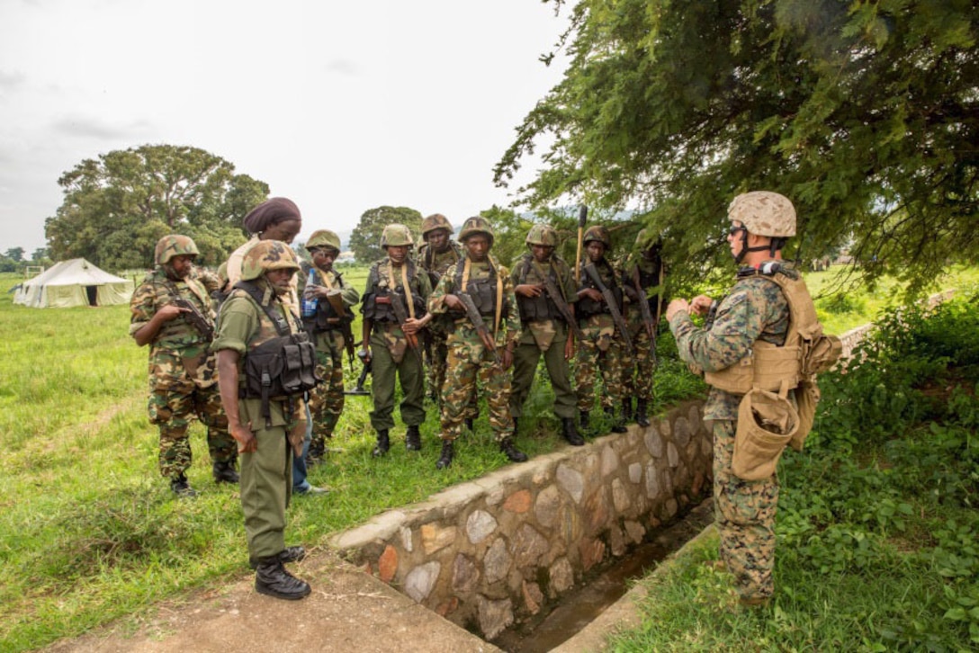 Staff Sergeant Gabriel Schaller discusses countering-improvised explosive devices techniques with soldiers from the Burundi National Defense Force (BNDF) in Bujumbura, Burundi, Nov. 6, 2014. Schaller is an explosive ordnance disposal technician with SPMAGTF-Crisis Response-Africa, training alongside the BNDF, teaching basic infantry tactics, engineering, logistical support, C-IED, lifesaving techniques and convoy operations to prepare them for an upcoming deployment in support of the African Union Mission in Somalia (AMISOM). Knowing what signs to look for and common places for hiding IEDs can save lives, especially in Somalia, where extremist regimes use them. (U.S. Marine Corps photo by Cpl. Shawn Valosin)