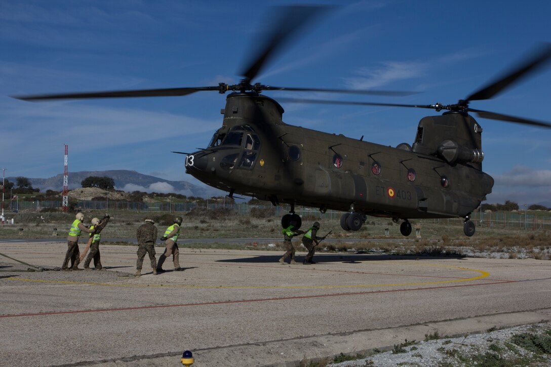 U.S. Marines with SPMAGTF Crisis Response - Africa and Spanish soldiers with Transport Helicopter Battalion 5, prepare to sling two water bladders to the bottom of the Spanish Army CH-47 Chinook, at Colmenar de Viejo, Spain, Nov. 18, 2014. The 4,300 pound water bladders can be used to transport clean water to support troops operating in a location without potable water or when conducting humanitarian assistance missions. The training enhanced mission readiness and help build relationships between the two militaries. (U.S. Marine Corps photo by Cpl Jeraco Jenkins/Released).