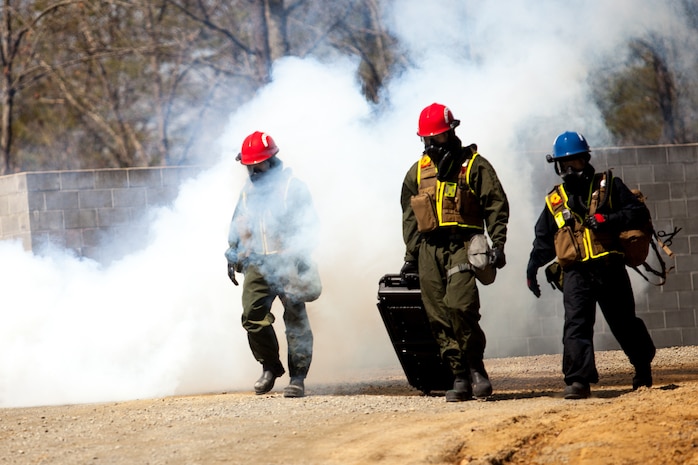 Marines and Sailors of the Chemical Biological Incident Response Force, II Marine Expeditionary Force, conduct a live chemical agent exercise at Fort A.P. Hill, Virginia on April 10. The unit conducted simulated casualty extraction in clouds of CS gas to prepare for real life evacuation situations. In order to execute its mission, CBIRF possesses a wide variety of unique skill sets that are task organized to address all possible aspects of a CBRNE attack. CBIRF has six major sections organic to the battalion: Explosive Ordnance Disposal, Technical Search and Rescue, Decontamination, Medical, Identification and Detection, and Search and Rescue/Casualty Extraction. (Official Marine Corps Photo by Sgt Kuande L. Hall/Released)


