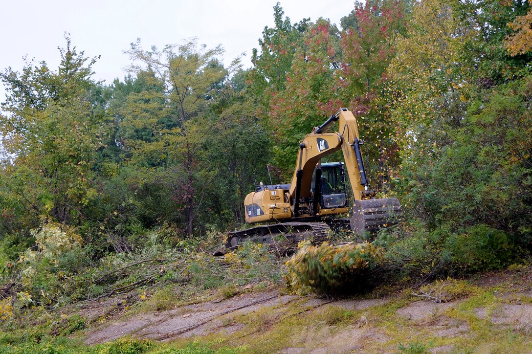 Removing vegetation that has encroached upon the work site. (USACE Photo/Brenda Beasley)