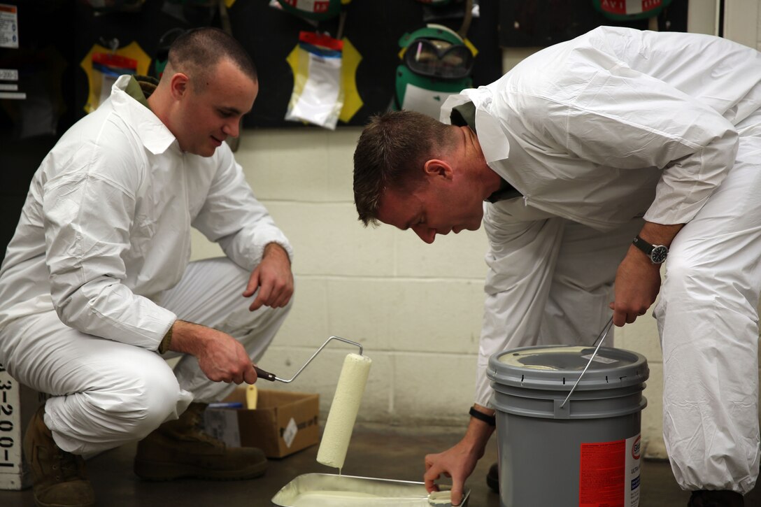 Cpl. Joseph Stabile, left, and Lt. Col. Marty Bedell prepare to paint the walls of Marine Transport Squadron 1 during renovations to the squadron's hangar at Marine Corps Air Station Cherry Point, N.C., Nov. 24, 2014. The Marines of VMR-1 pitched in to assist with recent renovations to the aging structure, improving their working conditions, increasing energy efficiency and saving tens of thousands of dollars in the process. Stabile is an avionics technician with VMR-1 and a native of Perth Amboy, N.J. Bedell is the commanding officer of the squadron and a native of Lexington, Va. 