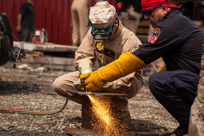 The Marines and Sailors of the Chemical Biological Incident Response Force (CBIRF), II Marine Expeditionary Force conduct training alongside the Fire Department of New York at their Fire Academy at Randall's Island, NY. The week-long training evolution includes rope training and high-angle rescue, vehicle extrication, response to structural collapse, and low-light search and rescue. These are all techniques used by CBIRF personnel when responding to chemical, biological, radiological, nuclear or high-yield explosive incidents (CBRNE). CBIRF is prepared to respond with minimal warning to crisis in order to assist local, state, or federal agencies and the geographic combatant commanders in the conduct of CBRNE response or consequence management operations. The Marines and Sailors that comprise CBIRF come from more than 40 military occupational specialties and train year round in a variety of venues with multiple agencies to carry out the unit’s unique mission.


