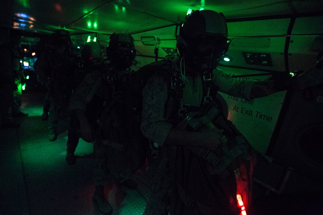 United States Marine Critical Skills Operators with 1st Marine Special Operations Battalion, Marine Corps Forces, Special Operations Command prepare to execute their final jump of a double-bag static line (DBSL) parachute training course, Aug 29, 2014, in rural Arizona. The DBSL course was an introduction to the High Altitude, High Opening (HAHO) insertion method utilized by Special Operations Forces. (U.S. Marine Corps Photo by Lance Cpl. Steven M. Fox/Released)