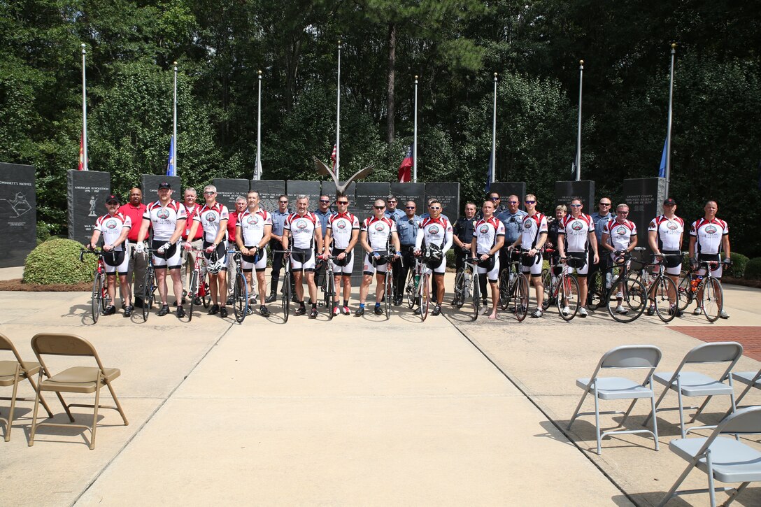 Marines and sailors with U.S. Marine Corps Forces Special Operations Command and volunteers and staff with Operation One Voice pose for a picture at the Fallen Heroes Memorial at the Gwinnett Justice Center in Lawrenceville, Ga., Sept. 11, 2014. (U.S. Marine Corps photo by Sgt. Donovan Lee/released)