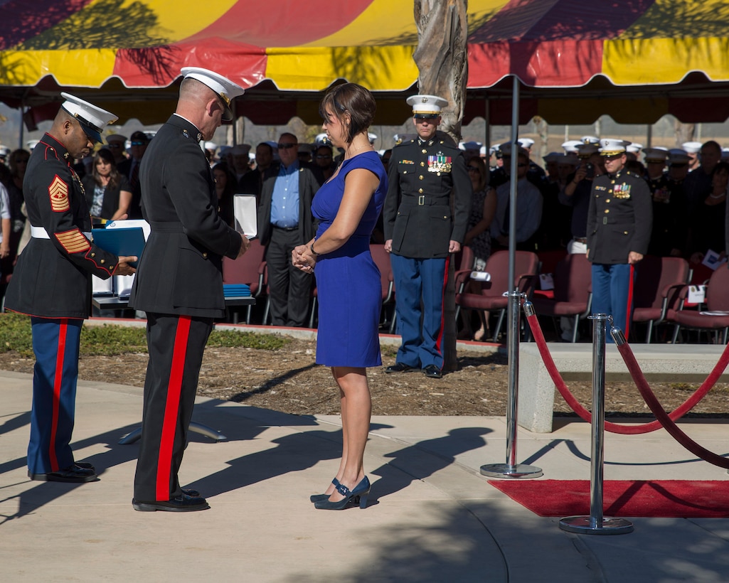 Major Gen. Joseph L. Osterman, commander of U.S. Marine Corps Forces Special Operations Command, assisted by Sgt. Maj. John Scott, MARSOC sergeant major, presents the Bronze Star posthumously to Staff Sgt. Nicholas Sprovtsoff, an Explosive Ordinance Technician, who was assigned to 1st MSOB.  Sprovtsoff’s wife, Tasha Sprovtsoff, accepts the award on his behalf aboard Camp Pendleton, Calif., Nov. 25, 2014.  (U.S. Marine Corps Photo by Sgt. Scott A. Achtemeier / Released)
