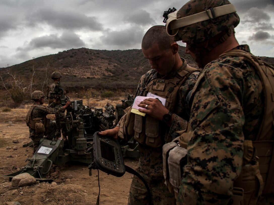 U.S. Marine Sgt. Ioan Cardos, left, shows Col. Vance L. Cryer how they operate the M777A2 Lightweight Howtizer during MEU Exercise 14 aboard Camp Pendleton, Calif., Nov. 20, 2014. Carlos is a gun chief with India Battery, Battalion Landing Team 3rd Battalion, 1st Marine Regiment, 15th Marine Expeditionary Unit. Cryer is the commanding officer for the 15th MEU. The purpose of MEUEX is to train the different elements of the 15th MEU to work together to complete a wide variety of missions. (U.S. Marine Corps photo by Cpl. Elize McKelvey/Released)