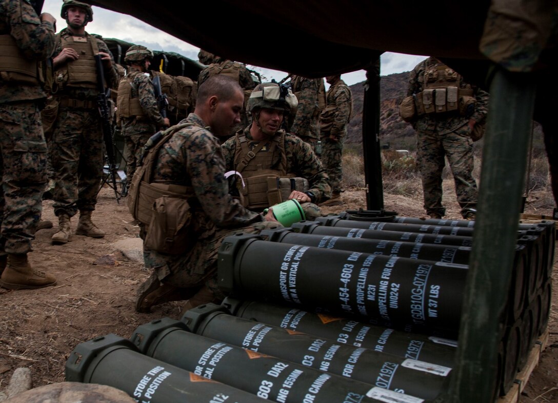 U.S. Marine Sgt. Ioan Cardos, left, shows Col. Vance L. Cryer the propellant used in the firing of the M777A2 Lightweight Howitzer during MEU Exercise 14 aboard Camp Pendleton, Calif., Nov. 20, 2014. Carlos is a gun chief with India Battery, Battalion Landing Team 3rd Battalion, 1st Marine Regiment, 15th Marine Expeditionary Unit. Cryer is the commanding officer for the 15th MEU. The purpose of MEUEX is to train the different elements of the 15th MEU to work together to complete a wide variety of missions. (U.S. Marine Corps photo by Cpl. Elize McKelvey/Released)