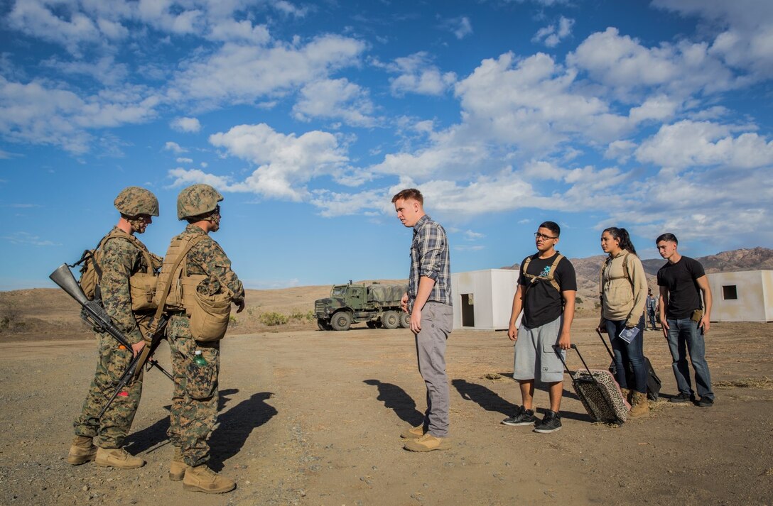 U.S. Marines with Combat Logistics Battalion 15, 15th Marine Expeditionary Unit, receive role players acting as American citizens at an evacuation control center during non-combatant evacuation operation training aboard Camp Pendleton, Calif., Nov. 19, 2014. The training is designed to improve Marines’ tactics in assisting the Department of State in evacuating U.S. citizens and civilian personnel from foreign nations to an appropriate safe haven. (U.S. Marine Corps photo by Sgt. Emmanuel Ramos/Released)