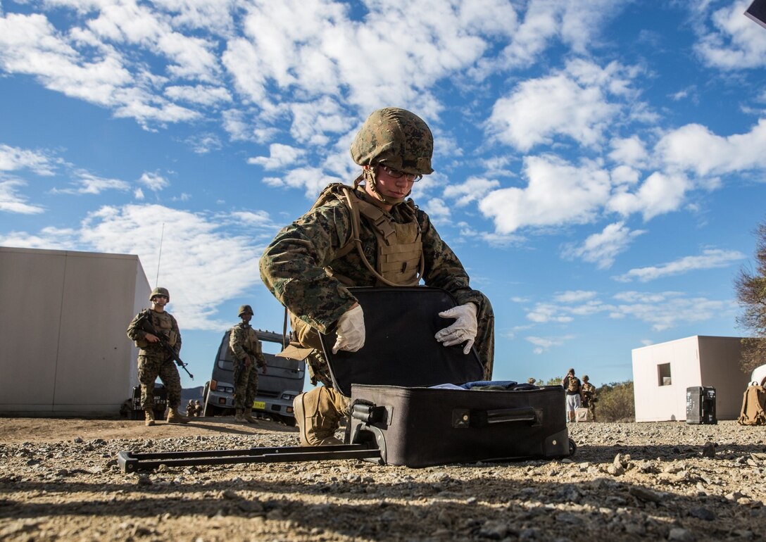 U.S. Marine Pfc. Chevon Ferrell-Collard searches for contraband during non-combatant evacuation operation training aboard Camp Pendleton, Calif., Nov. 19, 2014. Ferrell-Collard is an ammunition technician with Combat Logistics Battalion 15, 15th Marine Expeditionary Unit. The training is designed to improve Marines’ tactics in assisting the Department of State in evacuating U.S. citizens and civilian personnel from foreign nations to an appropriate safe haven. (U.S. Marine Corps photo by Sgt. Emmanuel Ramos/Released)