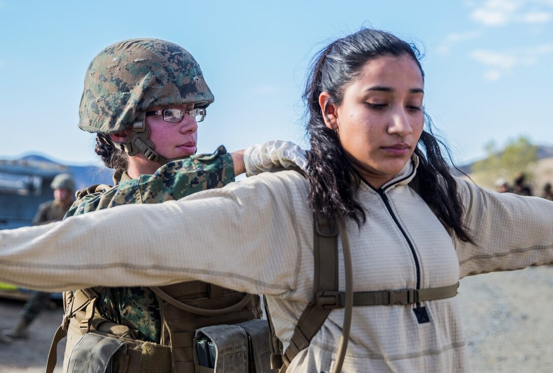 U.S. Marine Pfc. Chevon Ferrell-Collard searches an evacuee for weapons and contraband during non-combatant evacuation operation training aboard Camp Pendleton, Calif., Nov. 19, 2014. Ferrell-Collard is an ammunition technician with Combat Logistics Battalion 15, 15th Marine Expeditionary Unit. The training is designed to improve Marines’ tactics in assisting the Department of State in evacuating U.S. citizens and civilian personnel from foreign nations to an appropriate safe haven. (U.S. Marine Corps photo by Sgt. Emmanuel Ramos/Released)