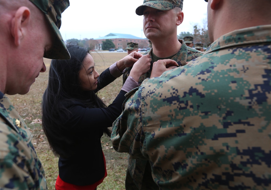U.S. Marine Corps Gunnery Sgt. Jerry Parramore, right, 22nd Marine Expeditionary Unit fires chief and native of West Palm Beach, Fla., has his current rank pinned on by his wife Roma Parramore, left, on Marine Corps Base Camp Lejeune, N.C., December 2, 2014. (U.S. Marine Corps photo by Cpl. Caleb McDonald/Released)