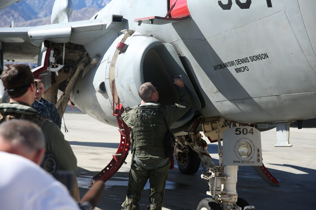 Navy Cmdr. Kirk Christofferson, squadron executive officer, Electronic Attack Squadron 134, signs a panel of the EA-6B ‘Prowler’ fixed-wing aircraft to represent his team as being the last crew to fly the aircraft during its retirement ceremony at the Palm Springs Air Museum, Nov. 21, 2014. VAQ 134 is an electronic warfare squadron based out of Naval Air Station Whidbey Island, Wash. (Official Marine Corps Photo by Lance Cpl. Julio McGraw/Released)