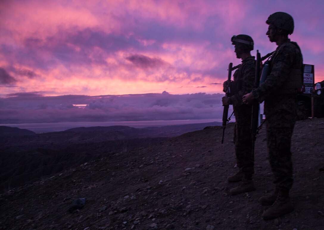 U.S. Marines with the 15th Marine Expeditionary Unit wait for the sun to set during MEU Exercise 14 aboard Camp Pendleton, Calif., Nov. 20, 2014. The purpose of MEUEX is to train the different elements of the 15th MEU to work together to complete a wide variety of missions. (U.S. Marine Corps photo by Cpl. Elize McKelvey/Released)