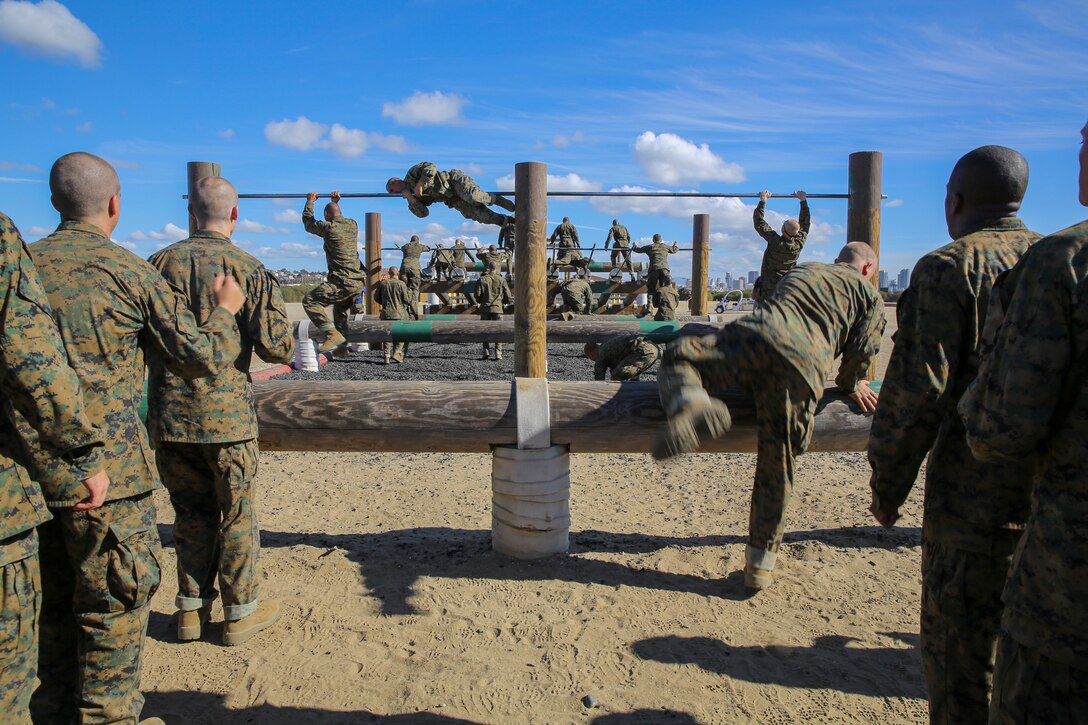 Recruits of Lima Company, 3rd Recruit Training Battalion, make their way up to the first obstacle during the Obstacle Course II event aboard Marine Corps Recruit Depot San Diego, Nov. 20.  After recruits went through the course, they had to run back to the beginning to execute the course again.