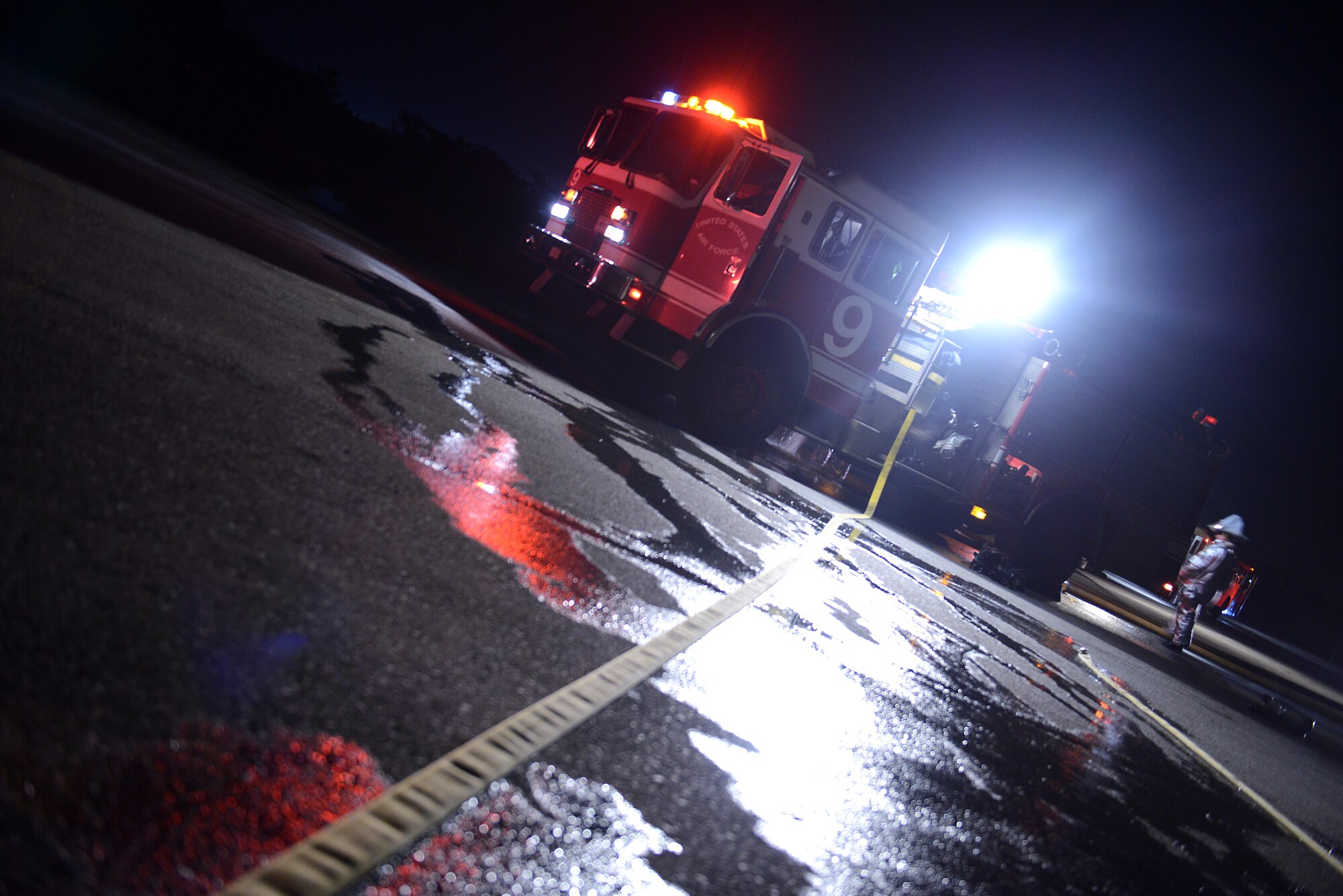 An 18th Civil Engineer Squadron firefighter returns to a Kadena fire truck following the successful recovery of a simulated car accident victim during a mission focused exercise on Kadena Air Base, Japan, Dec. 3, 2014. The MFE, which tests Airmen on their ability to survive and operate in a multitude of stressful environments, is scheduled to run through Dec. 4. (U.S. Air Force photo by Senior Airman Maeson L. Elleman/Released) 