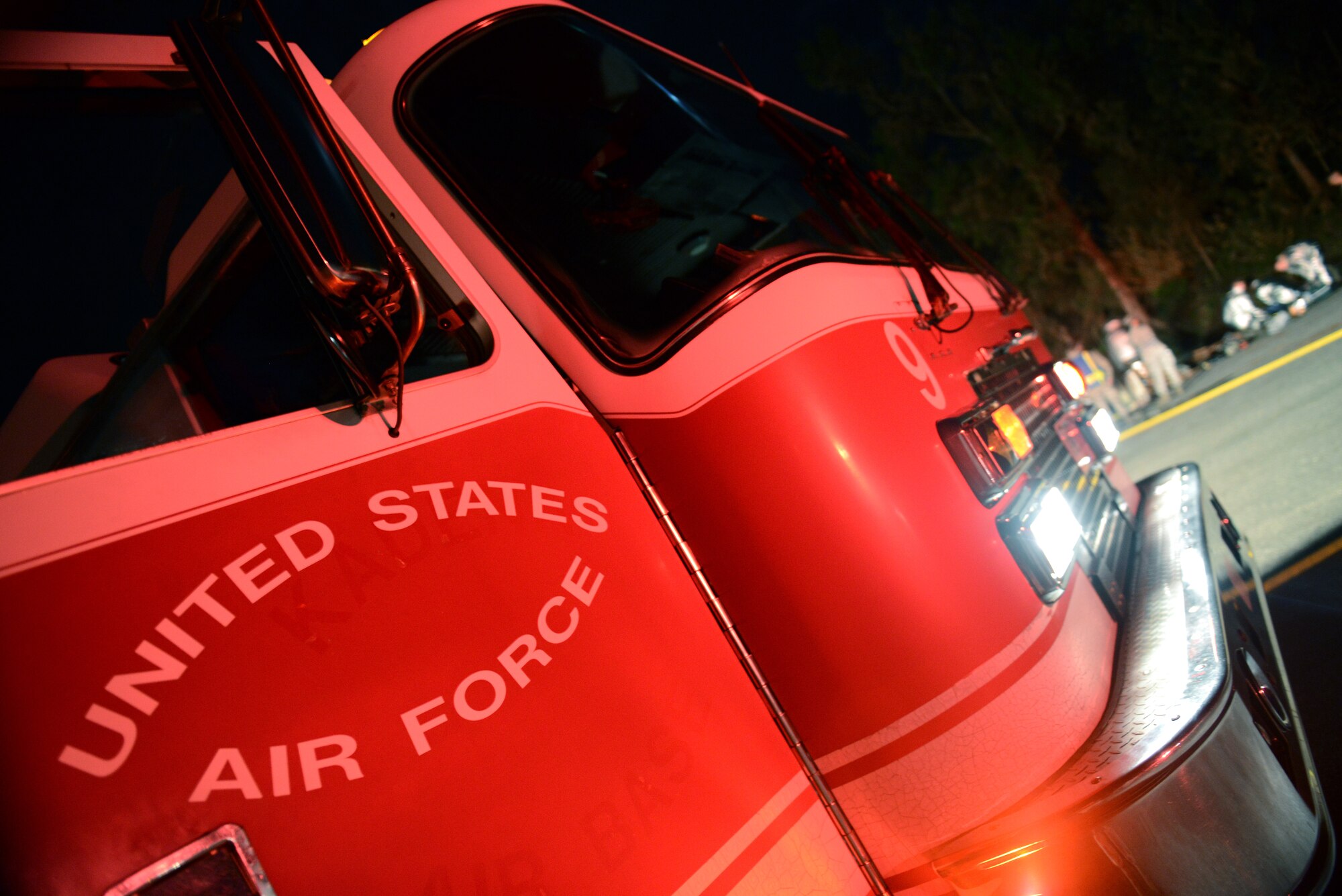 An 18th Civil Engineer Squadron fire truck is parked near the scene of a simulated vehicle crash as part of a mission focused exercise on Kadena Air Base, Japan, Dec. 3, 2014. The MFE, which tests Airmen on their ability to survive and operate in a multitude of stressful environments, is scheduled to run through Dec. 4. (U.S. Air Force photo by Senior Airman Maeson L. Elleman/Released) 