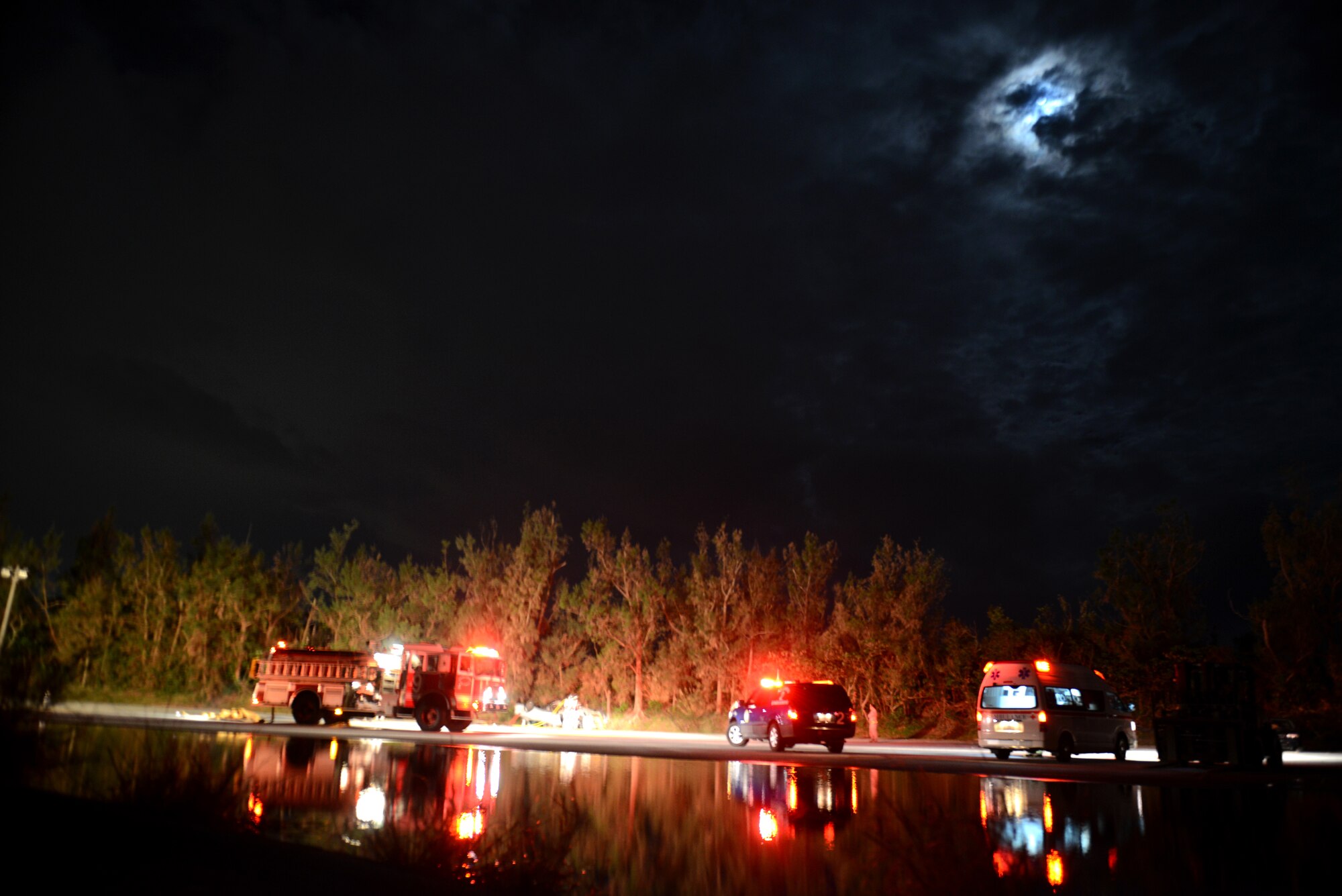 Kadena emergency response vehicles are parked around the scene of a simulated vehicle accident as part of a mission focused exercise on Kadena Air Base, Japan, Dec. 3, 2014. The exercise tested Kadena emergency responders like firefighters, security forces members and medical personnel on their ability to quickly administer life-saving techniques in a stressful environment.  (U.S. Air Force photo by Senior Airman Maeson L. Elleman/Released) 