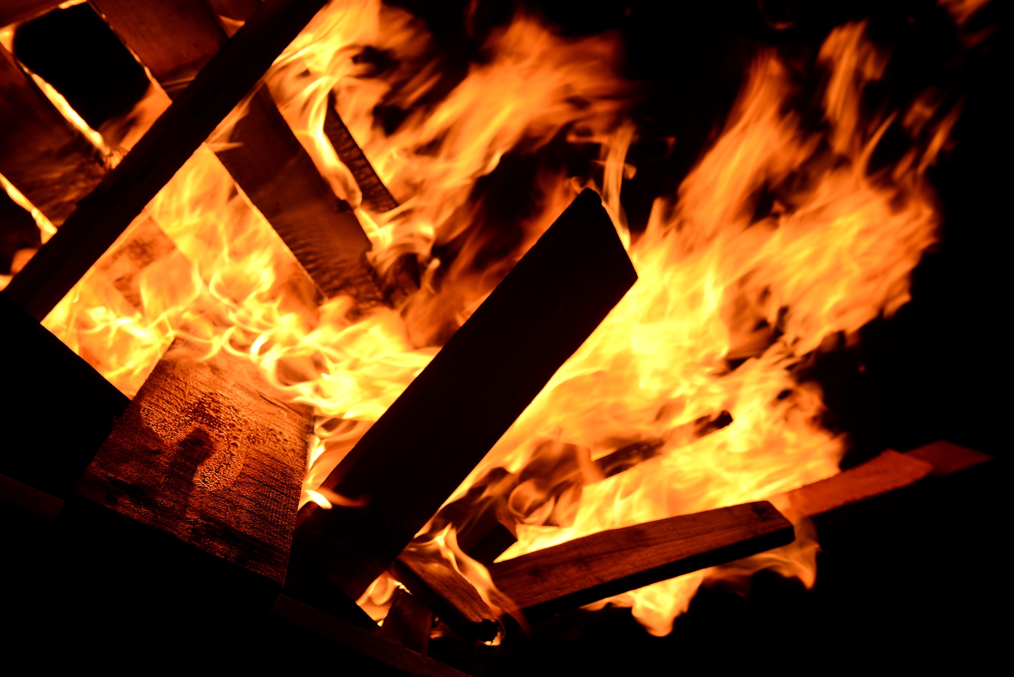Fire burns at the scene of a simulated vehicle accident as part of a mission focused exercise on Kadena Air Base, Japan, Dec. 3, 2014. The MFE, which tests Airmen on their ability to survive and operate in a multitude of stressful environments, is scheduled to run through Dec. 4. (U.S. Air Force photo by Senior Airman Maeson L. Elleman/Released) 