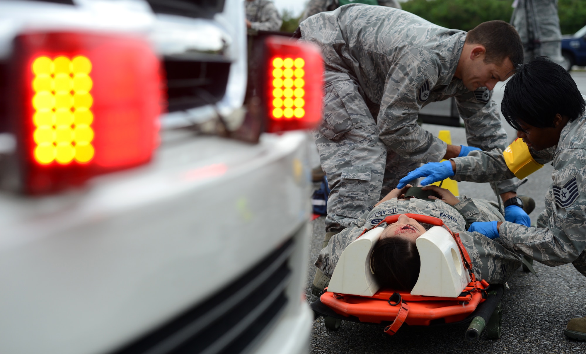 U.S. Air Force emergency medical responders strap a victim of a simulated car accident to a litter during a mission focused exercise on Kadena Air Base, Japan, Dec. 2, 2014. The MFE is designed to train Airmen on Kadena proper techniques and procedures for an array of scenarios from active shooters to unexploded ordnance response. (U.S. Air Force photo by Senior Airman Maeson L. Elleman/Released) 