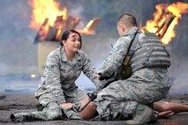 A simulated victim of a vehicle accident speaks with an 18th Security Forces Squadron first responder as part of a mission focused exercise on Kadena Air Base, Japan, Dec. 2, 2014. The exercise tested Kadena emergency responders from firefighters to security forces members and medical personnel on their ability to quickly administer life-saving techniques in a stressful environment. (U.S. Air Force photo by Senior Airman Maeson L. Elleman/Released)