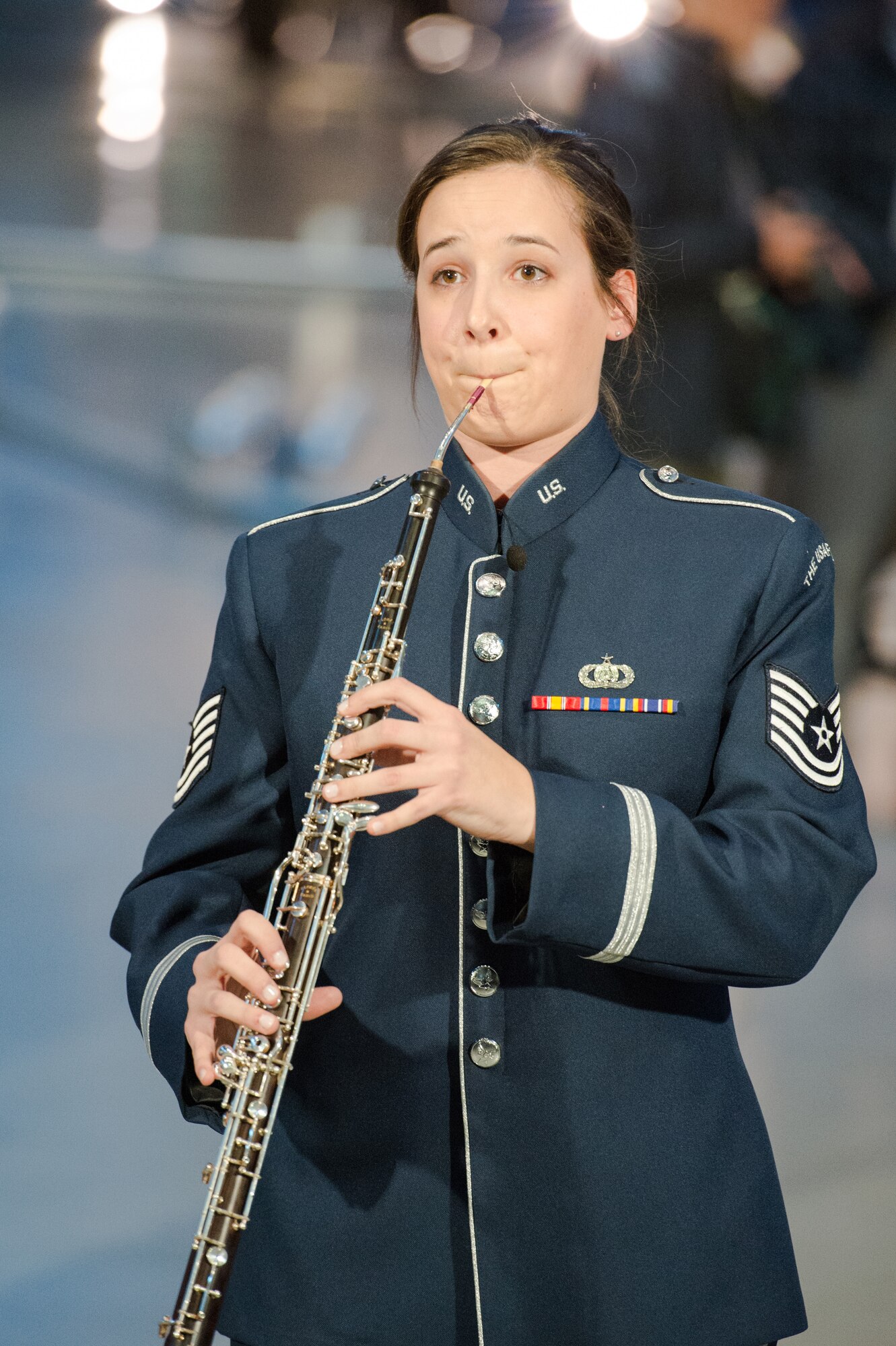 Tech Sgt. Emily Snyder, United States Air Force Concert Band English hornist, begins playing the traditional English Folk song, “Greensleeves”, at the Smithsonian National Air and Space Museum Udvar-Hazy Center in Chantilly, Va., Dec. 2, 2014. The band conducted a flash mob to promote their free, upcoming holiday concerts in the National Capital Region. (U.S. Air Force photo/ Staff Sgt. Devon Suits)