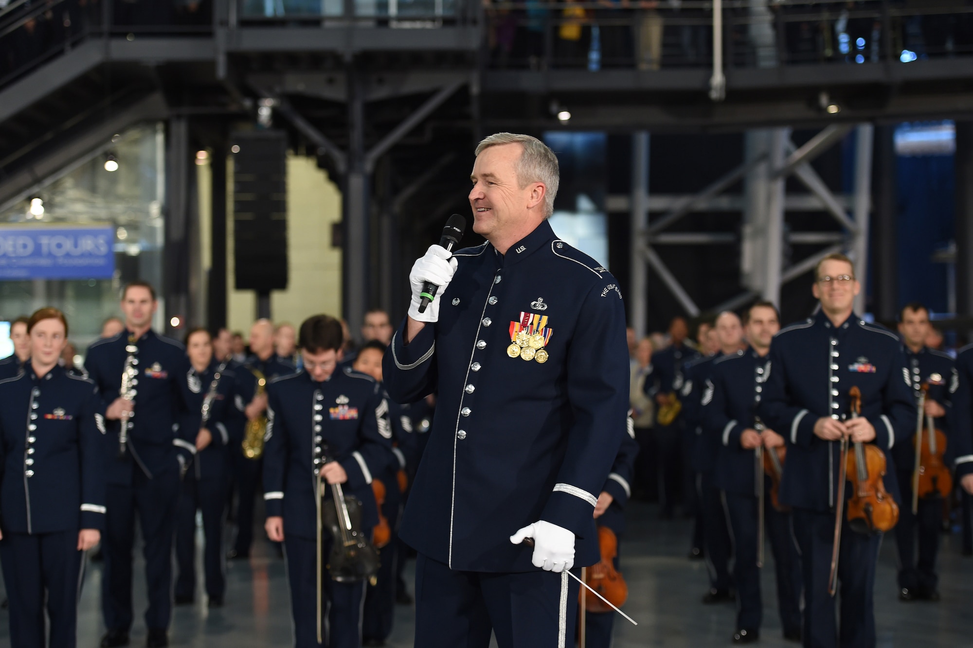 Col. Larry H. Lang, United States Air Force Band commander, thanks audience members after their flash mob at the Smithsonian National Air and Space Museum Udvar-Hazy Center in Chantilly, Va., Dec. 2, 2014. Approximately 160 band members played for museum spectators promoting their free, upcoming holiday concerts in the National Capital Region. (U.S. Air Force photo/Senior Airman Nesha Humes)
