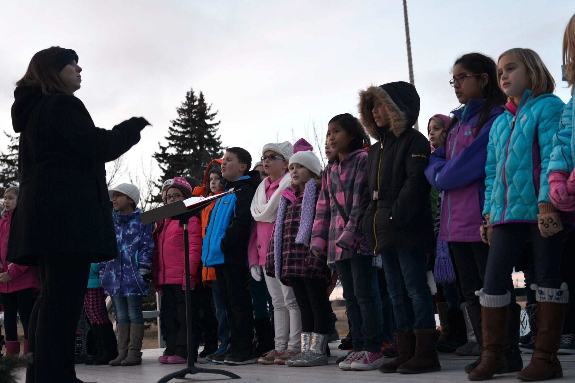 Students from Michael Anderson Elementary School sing Christmas carols during the annual tree lighting ceremony Dec. 1, 2014, at Fairchild Air Force Base, Wash. Members of Team Fairchild gathered at the base chapel to officially start the holiday season. (U.S. Air Force photo/Airman 1st Class Janelle Patiño)