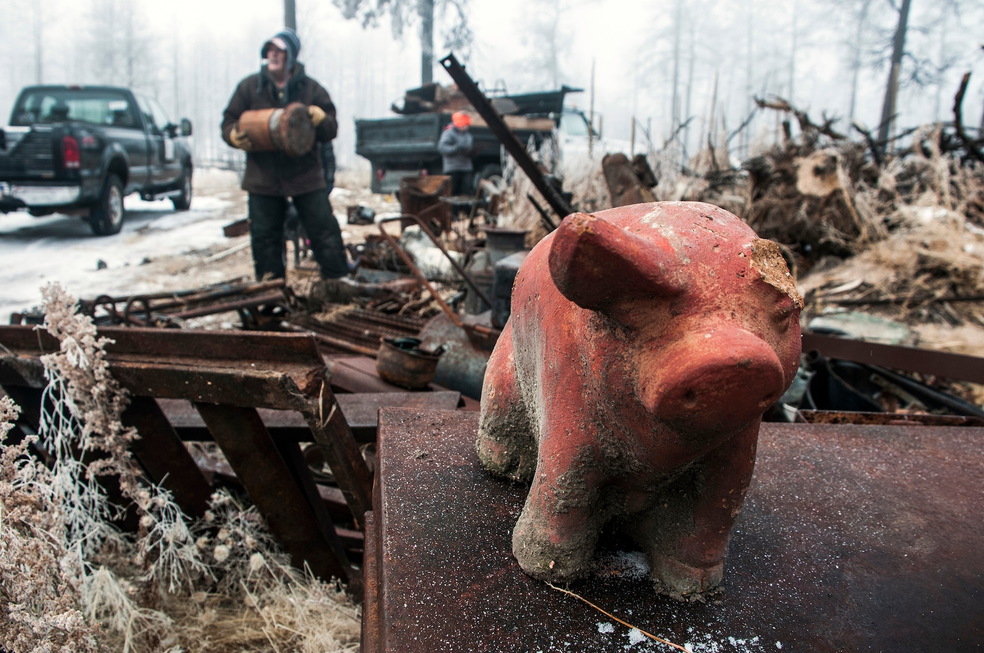 A piggybank standing atop other debris is among the remnants of a home destroyed by the 2013 fire at Black Forest, Colo. Members of the 25th and 379th Space Range Squadrons piled scrap metal and other materials Nov. 26, 2014, at Black Forest, Colo., as part of the squadrons’ volunteer effort through the non-profit Black Forest Together. (U.S. Air Force photo/Staff Sgt. Julius Delos Reyes)