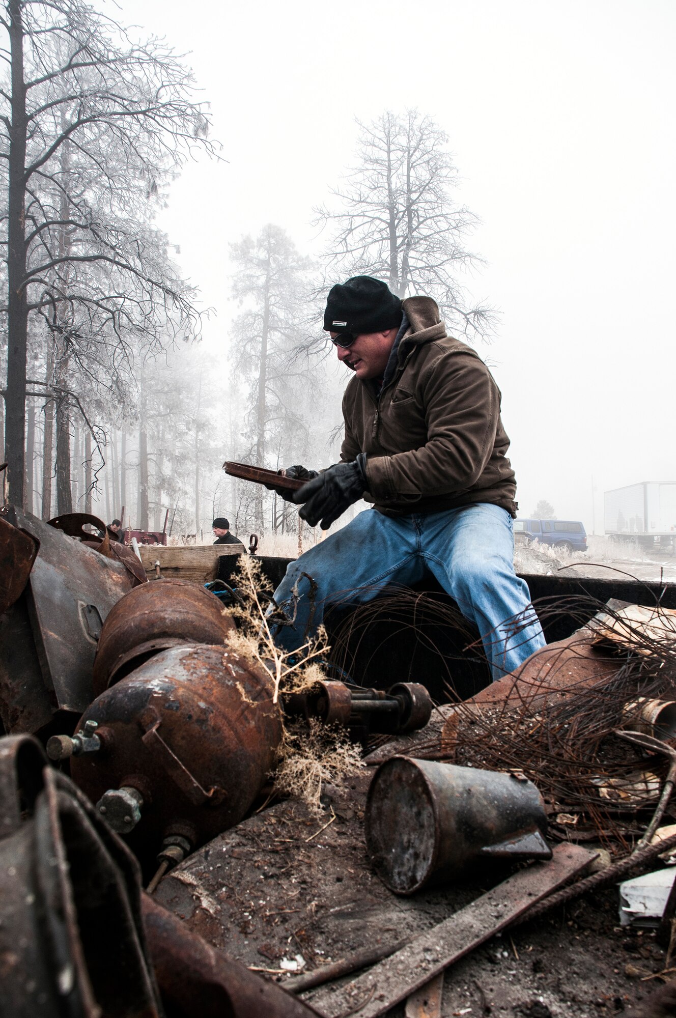 Lt. Col. Phil Verocco, 25th Space Range Squadron, sorts through a pile of scrap metal Nov. 26, 2014, at Black Forest, Colo. Airmen and family members with the 25 SRS and 379th Space Range Squadron from Schriever Air Force Base, Colo., volunteered their time through Black Forest Together, a non-profit organization that is designed to help Black Forest fire victims recover from the 2013 fire and mitigate future fires. (U.S. Air Force photo/Staff Sgt. Julius Delos Reyes)