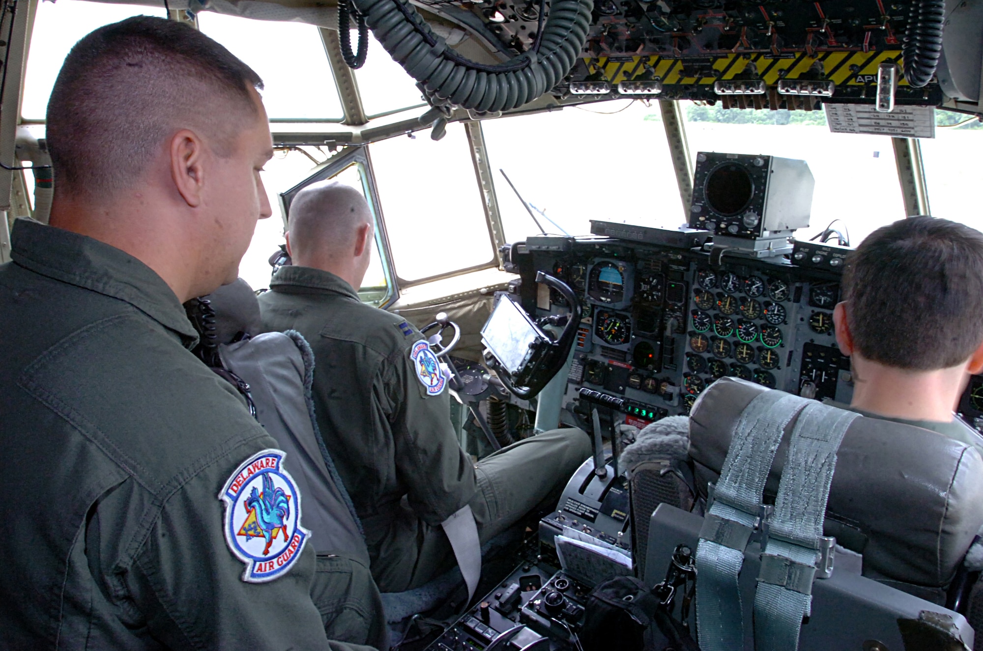 Delaware Air National Guard C-130 Hercules aircrew, from left, Master Sgt. Mike Murphy, flight engineer, Capt. Troy Bockius, aircraft commander and 1st Lt. Anthony Carunchio, pilot, prepare to taxi their aircraft at the New Castle Air National Guard Base, Del., June 14, 2007 for a training flight commemorating the 166th Airlift Wing's 160,000th accident-free flight hour. (National Guard Bureau photo by Tech. Sgt. Mike R. Smith)