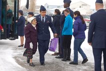 Team Minot Airmen escort senior citizens during the Day of Love event on Minot Air Force Base, N.D., Nov. 27, 2014. Nearly 100 military and civilian members volunteered at the event, which has been going on since 1969. Senior citizens from across Minot, N.D., and surrounding communities travel to the base to eat a Thanksgiving meal and enjoy the company of Team Minot’s family. (Courtesy photo) 