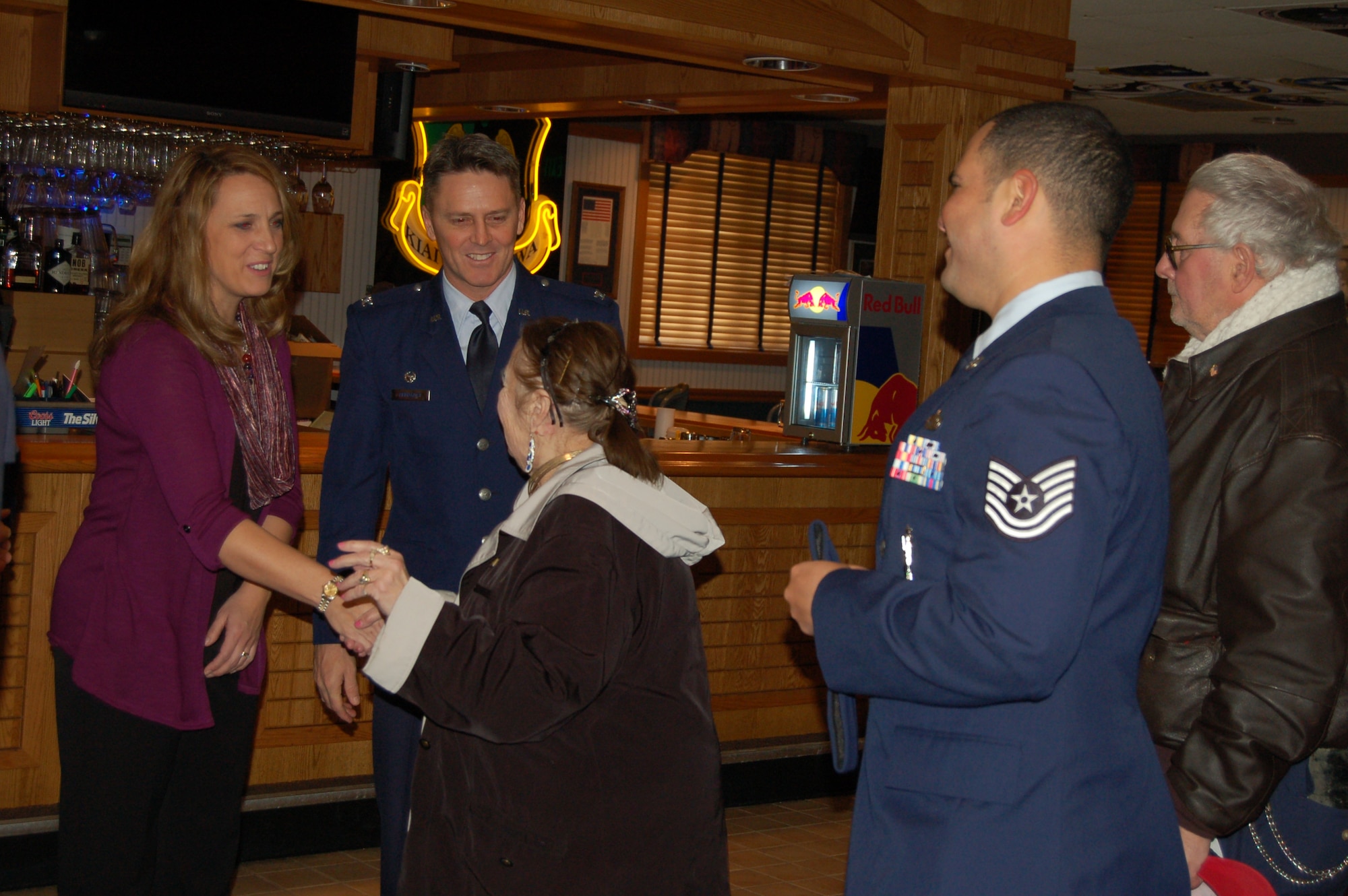 Col. Jason Armagost, 5th Bomb Wing commander, and his wife Diane Armagost greet guests at the Day of Love event on Minot Air Force Base, N.D., Nov, 27, 2014. Nearly 100 military and civilian members volunteered at the event, which has been going on since 1969. Senior citizens from across Minot, N.D., and surrounding communities travel to the base to eat a Thanksgiving meal and enjoy the company of Team Minot’s family. (Courtesy photo)  
