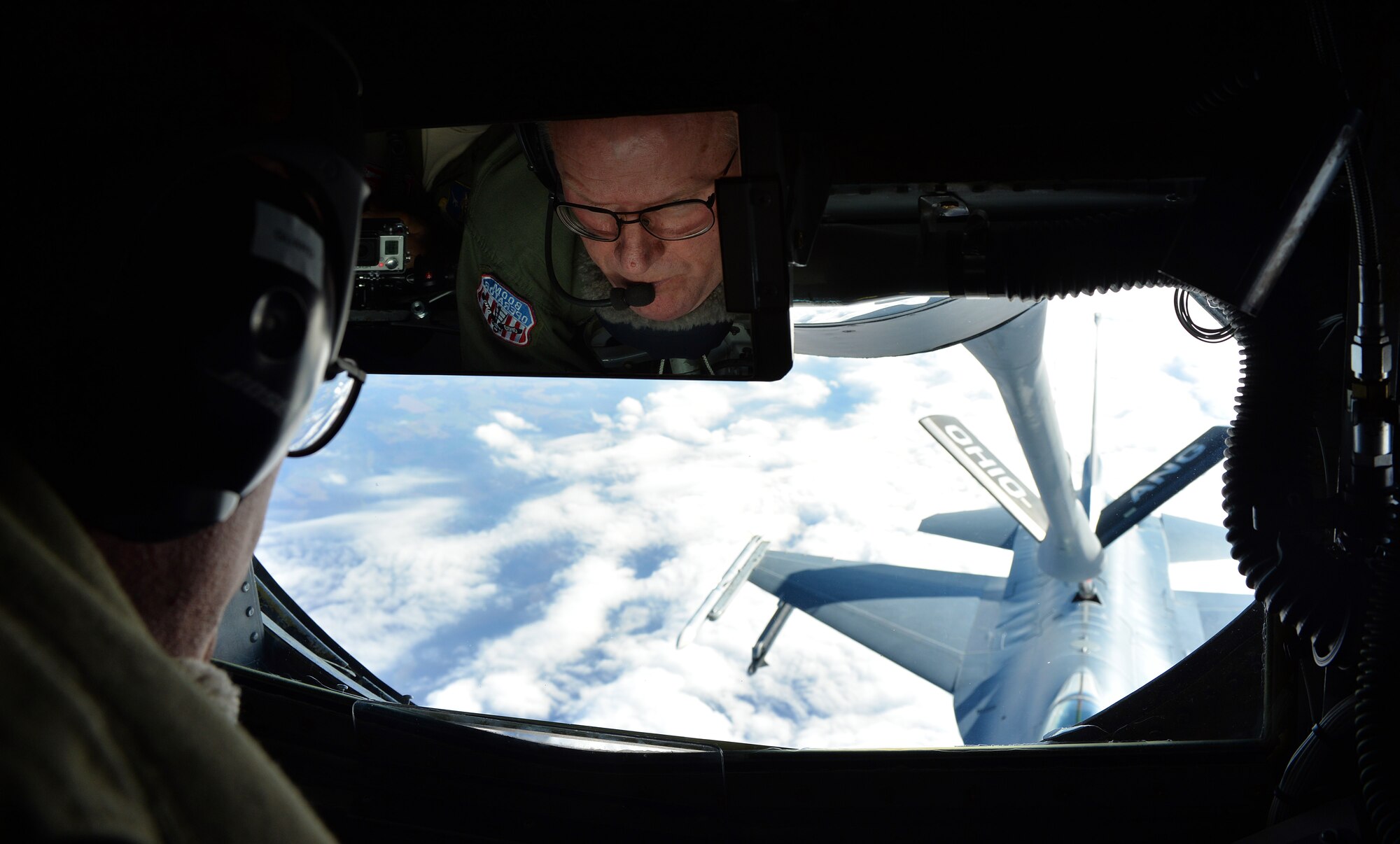 Chief Master Sgt. Tom Guard, a KC-135 Stratotanker boom operator in the 121st Air Refueling Wing, refuels an F-16 Fighting Falcon from the 180th Fighter Wing, Ohio in the skies over Ohio Nov. 26, 2014. Guard was taking his final flight after 41 years of service in the military and is set to retire on Dec. 19, 2014. (U.S. Air National Guard photo by Master Sgt. Ralph Branson/Released)