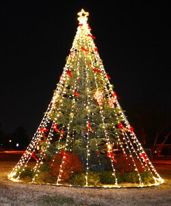 The holiday tree illuminates the roundabout near the King Street Gate at Langley Air Force Base, Va., Dec. 1, 2014. A tree-lighting ceremony included music, entertainment and a holiday social. (U.S. Air Force photo by Airman 1st Class Devin Scott Michaels/Released)