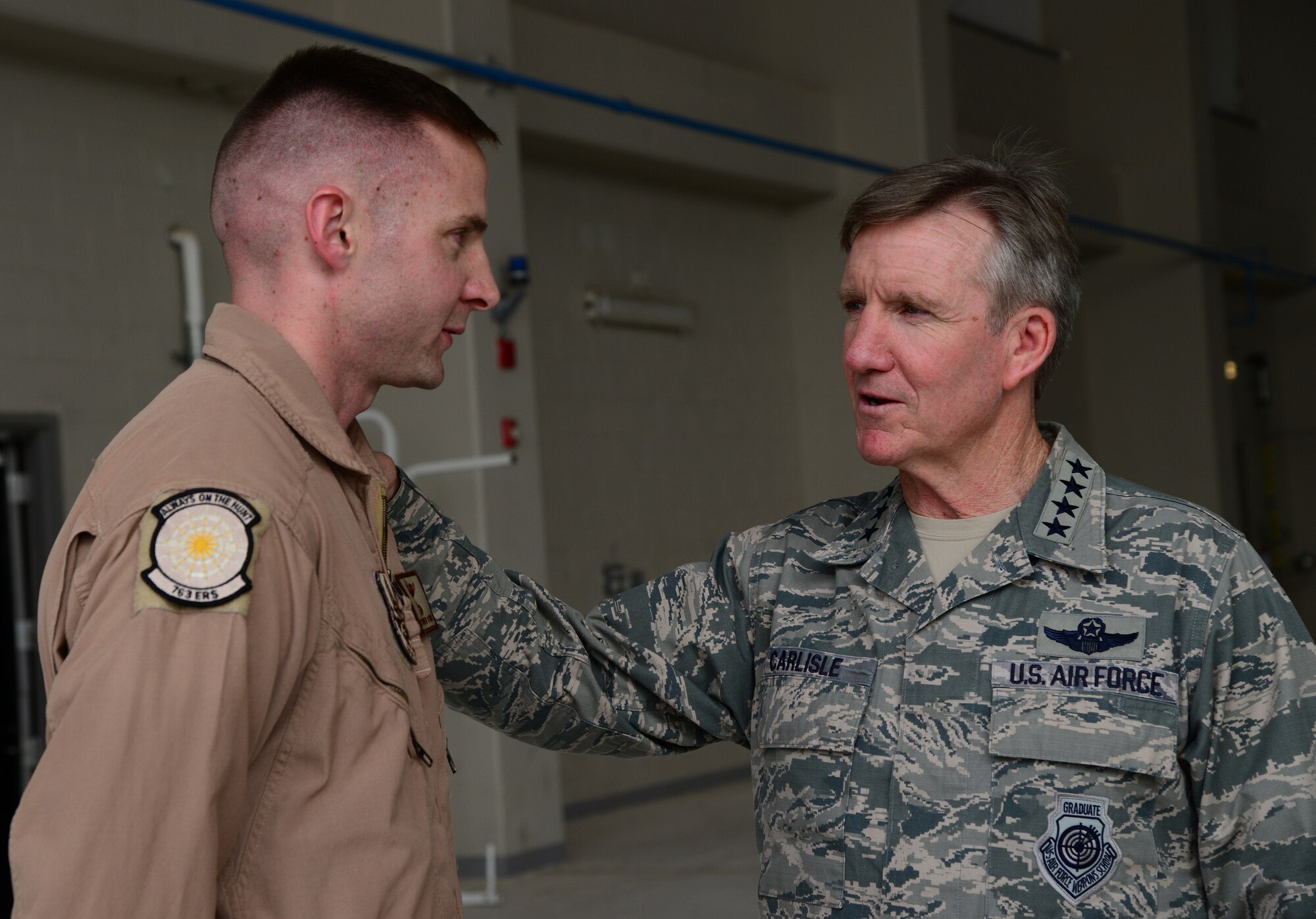 U.S. Air Force Gen. Hawk Carlisle, commander of Air Combat Command, thanks Tech. Sgt. Matthew Otteman, 763rd Expeditionary Reconnaissance Squadron, during his base visit, Nov. 25, 2014, at Al Udeid Air Base, Qatar. Otteman, who is a production supervisor, was selected by his leadership to represent his squadron. (U.S. Air Force photo by Senior Airman Kia Atkins)