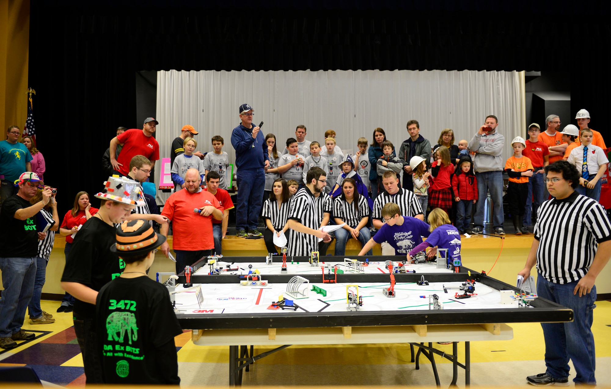 Two teams make last-minute adjustments during their portion of the robotics competition Nov. 22, 2014. Junior high school students from the O’Fallon and Edwardsville school districts (plus home-schooled teams) competed at Carriel Junior High School in O’Fallon in the FIRST (For Inspiration and Recognition of Science and Technology) robotics tournament. (U.S. Air Force photo/ Staff Sgt. Stephenie Wade)