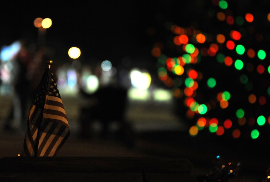An American flag stands in the bed of Santa Claus’ truck during the base tree lighting ceremony at Seymour Johnson Air Force Base, North Carolina, Dec. 1, 2014. Interacting with Santa and his elves was one of many holiday-themed activities Airmen and their families enjoyed at the event. (U.S. Air Force photo/Senior Airman Ashley J. Thum)
