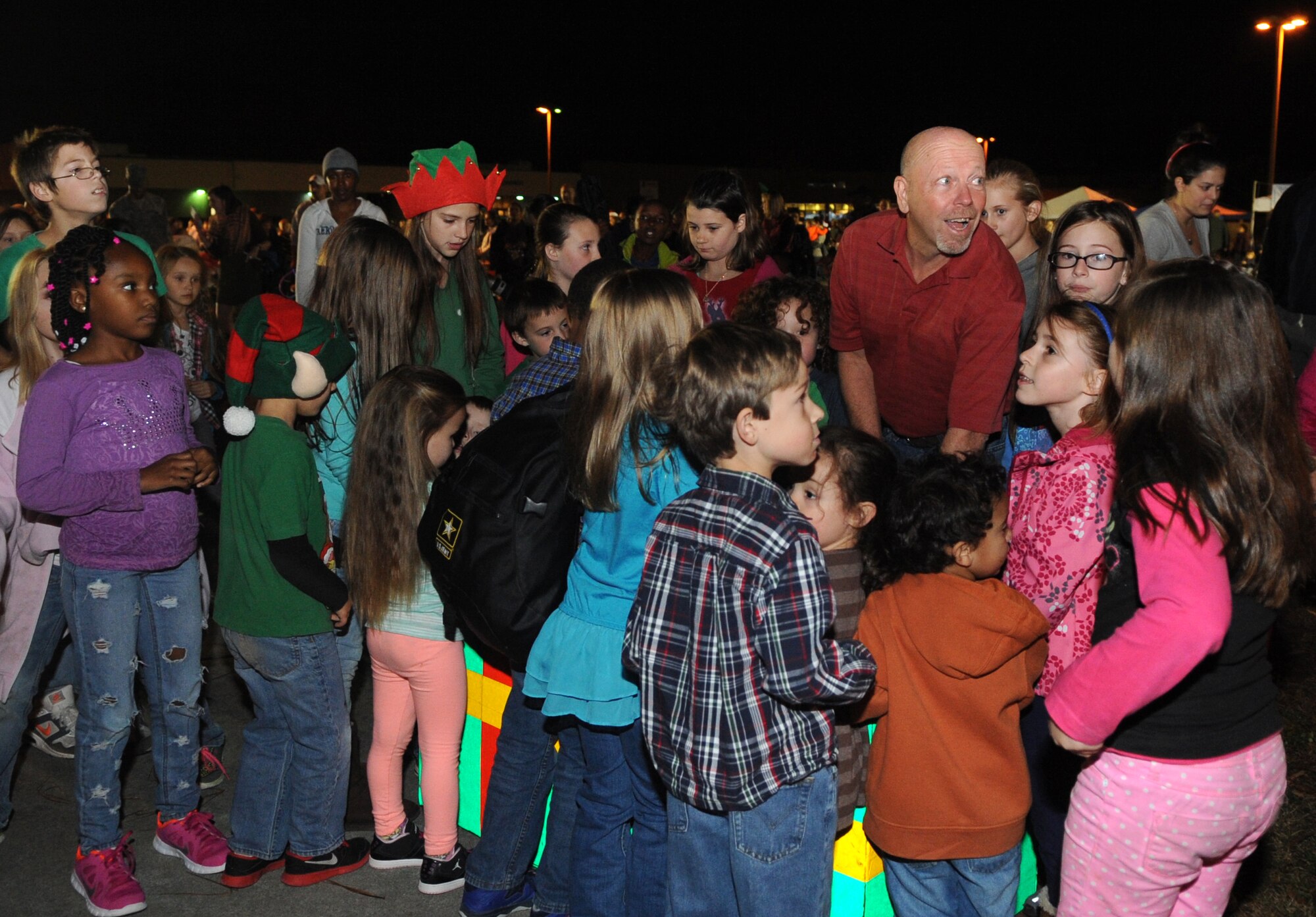 Team Seymour’s younger members huddle around the switches during the base tree lighting ceremony at Seymour Johnson Air Force Base, North Carolina, Dec. 1, 2014. Mark Slocum, 4th Fighter Wing commander, enlisted the help of the kids and counted down to the moment when the group threw the switches to light the tree. (U.S. Air Force photo/Senior Airman Ashley J. Thum)